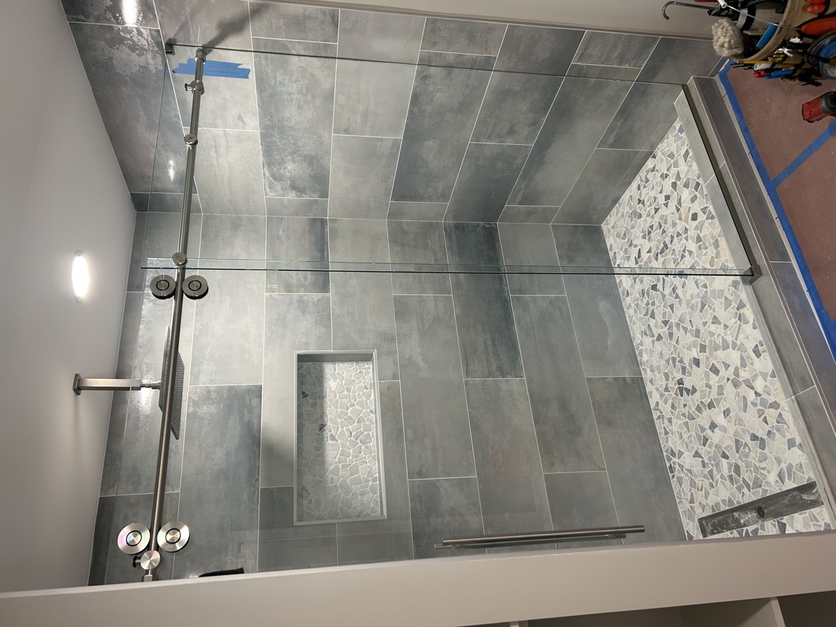 Custom shower enclosure with brushed hardware