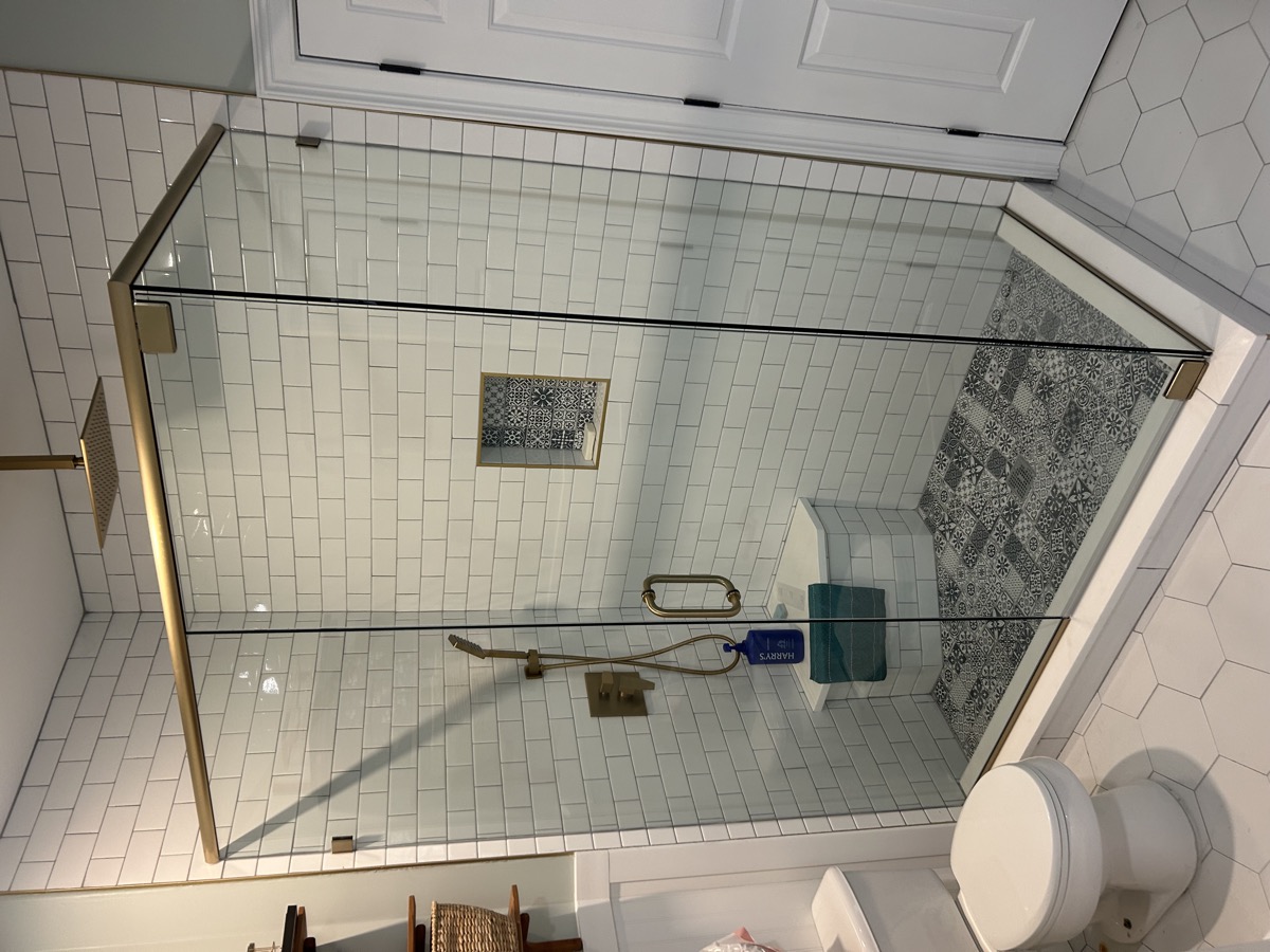 Frameless glass shower door on tile